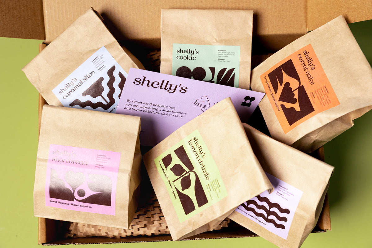An open Shelly's gift box filled with wrapped treats
